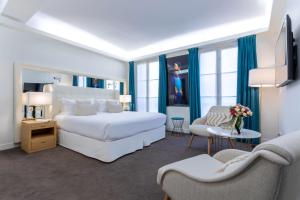 Habitación de hotel con 1 dormitorio con 2 camas y sillas en Hotel Camille Paris Tapestry Collection by Hilton, en París