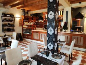 a restaurant with a table and chairs and a bar at Residence San Miguel (3) in Vicenza