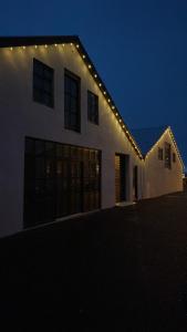 a white house with lights on it at night at Heppa Apartments in Höfn