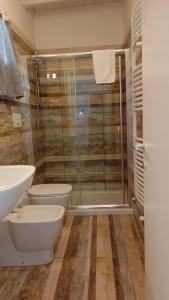 y baño con ducha, aseo y lavamanos. en Villa Raggio di Sole parcheggio privato, en Porto Cesareo
