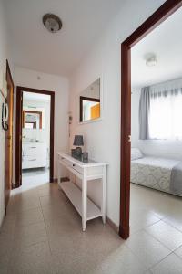a bedroom with a white desk and a bed at Hola Mar in Torrevieja