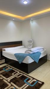 a bedroom with a large bed with a rug at شقة فندقية فاخرة luxury apartment sea view in Alexandria