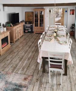 a dining room with a white table and chairs at Vila Chic M in Moieciu de Jos