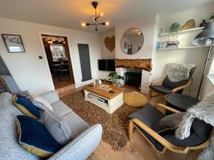 a living room with a couch and chairs and a table at 4 Danes Cottages - perfect location in Lincoln