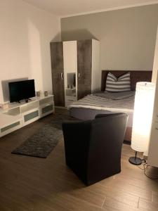 a bedroom with a bed and a flat screen tv at Ländliche Idylle in Neu Bötzow