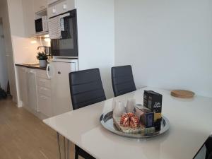 a kitchen with a counter with a plate of food on it at Bright studio apartment on the 6th floor in Kerava