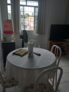 a table with a white table cloth on it at no centro de Cuiabá aptº mobiliado in Cuiabá