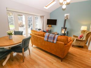 a living room with a couch and a table at Pengwern Bach in Llanrwst