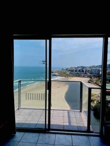 a room with a view of a beach and the ocean at Santana Holiday Resort 1002 in Margate