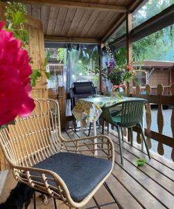 a patio with a table and chairs on a deck at Chalet Rent Porlezza in Porlezza