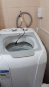 a white toilet with a cord on top of it at no centro de Cuiabá aptº mobiliado in Cuiabá +6 photos