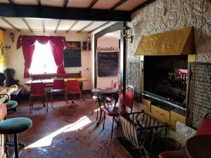 a room with a table and chairs and a fireplace at Prince of Wales inn in Caerphilly