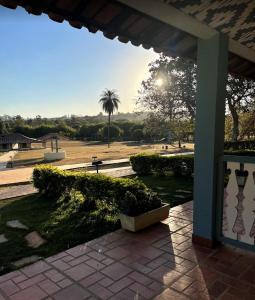 a view of a park with a palm tree in the background at Sertão Veredas Hotel Fazenda in Paraopeba