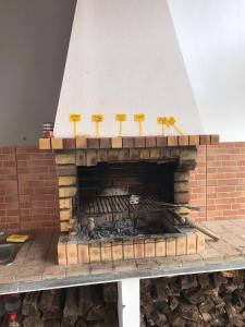a brick fireplace being constructed with yellow spatulas at Modern room (with deck) in Povoação