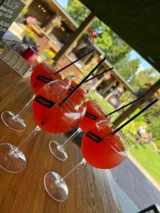 a group of four wine glasses sitting on a table at The Hinds Head Hotel in Chorley