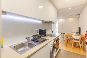 a kitchen with a sink and a dish washer at I Love Vila do Conde in Vila do Conde