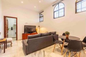 a living room with a couch and a table at Luxury apartamento Sevilla centro -triana in Seville
