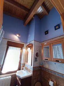 a bathroom with a sink and a toilet and a window at Cuarenta y Ocho Luces in Burgos