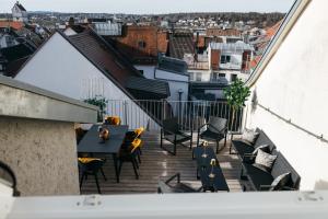 a patio with a table and chairs on a balcony at HEIMATEL - Luxury Penthouse Loft in Ravensburg