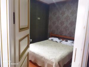 a small bedroom with a bed in a room at Quba Guest House 
