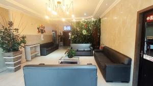 uma sala de estar com sofás e plantas na parede em Hotel Ipê em Belém