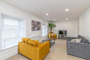 a living room with two couches and a tv at Eden Grove Holiday Retreat in Kirkby Thore