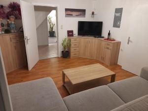 a living room with a couch and a coffee table at Holiday Home Doris in Bad Goisern