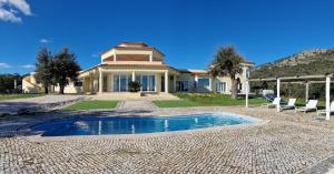 a house with a swimming pool in front of it at Herdade do Montinho in Portalegre