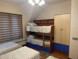 a bedroom with two bunk beds at Beautiful Guest House Qusar in Qusar