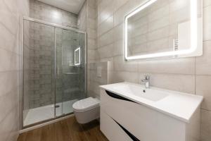 a bathroom with a sink and a shower and a toilet at IMMOBILIARE Lux Tram in Luxembourg