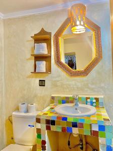 a bathroom with a sink and a mirror at Riad Fes EL KAID in Fez +177 photos