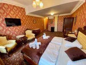 a hotel room with two beds and a tv at Hotel Liliova Prague Old Town in Prague