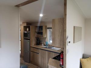 a small kitchen with a sink and a stove at Plompton Mill Holiday Home in Knaresborough