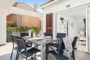 a dining room with a table and chairs on a patio at Casa Hawaii in Port d'Alcudia