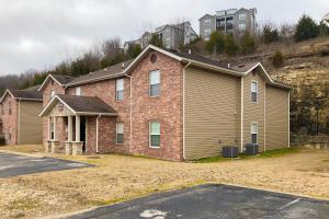 a large brick house with a yard in front at Vinyard Ventures, Unit #3 in Branson