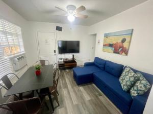 a living room with a blue couch and a table at Sunflower Boutique Hotel Apartments in Miami Beach