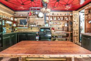a kitchen with a wooden table in a room at Edward - The Hut in Acworth