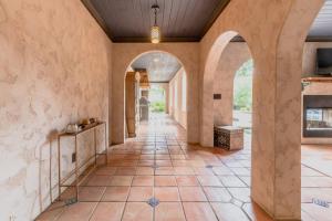 an empty hallway with arches and a tiled floor at Villa Flora in Marietta