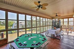 a large room with a table and chairs and windows at New Orleans Waterfront Home with Private Dock! in New Orleans