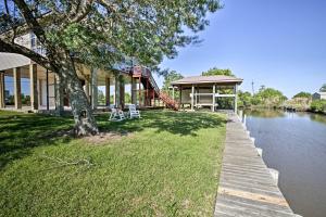 a house with a playground next to a river at New Orleans Waterfront Home with Private Dock! in New Orleans