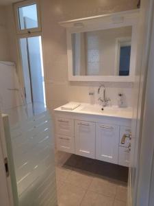 a white bathroom with a sink and a mirror at Kosher Airbnb very close to Central Bus Station in Jerusalem