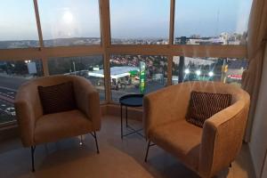 two chairs and a table in a room with a window at Kosher Airbnb very close to Central Bus Station in Jerusalem