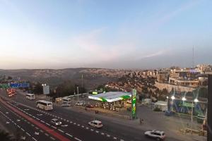 a view of a highway with cars and buildings at Kosher Airbnb very close to Central Bus Station in Jerusalem