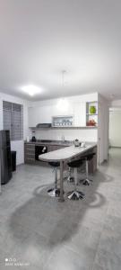 a kitchen with a table in the middle of a room at Apartamento vista a la montaña in Girardot