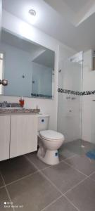 a bathroom with a toilet and a sink and a shower at Apartamento vista a la montaña in Girardot