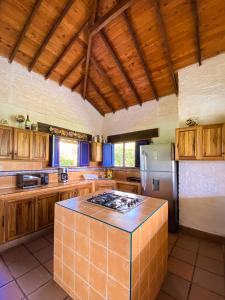 een keuken met houten kasten en een koelkast bij Private nature surrounded House with Kiosk/Pool. in Riveralta