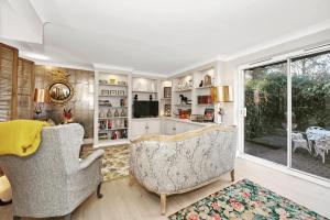 a living room with two chairs and a window at 2 Bedroom stylish property set behind the angel hotel with parking and a courtyard garden in Bury Saint Edmunds