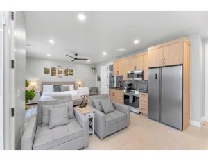 a bedroom with a bed and a living room with a kitchen at Desert Hideaway in Hurricane