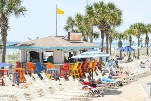 a group of people sitting in chairs on the beach at The Summit Condo Resort in Panama City Beach