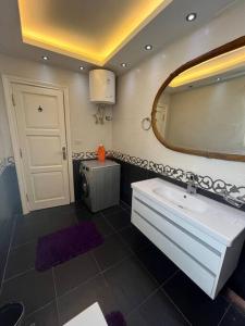 a bathroom with a sink and a mirror at Unique apartment in Almaza in Cairo